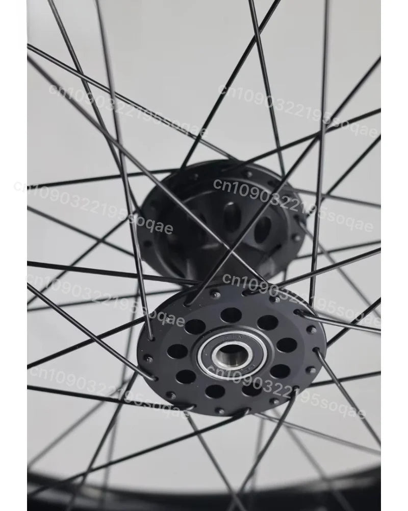 MobilityBuy.com 24-inch fat-tire wheelchair wheel with black hub and multiple spoke holes