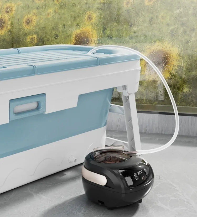 Portable folding bathtub for adults in blue and white with lid, connected to a black spa heater by MobilityBuy.com