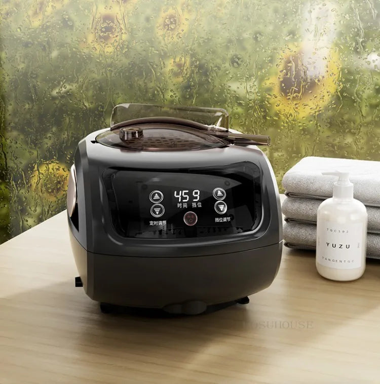 Electric black air fryer with digital control panel and clear lid on wooden counter.