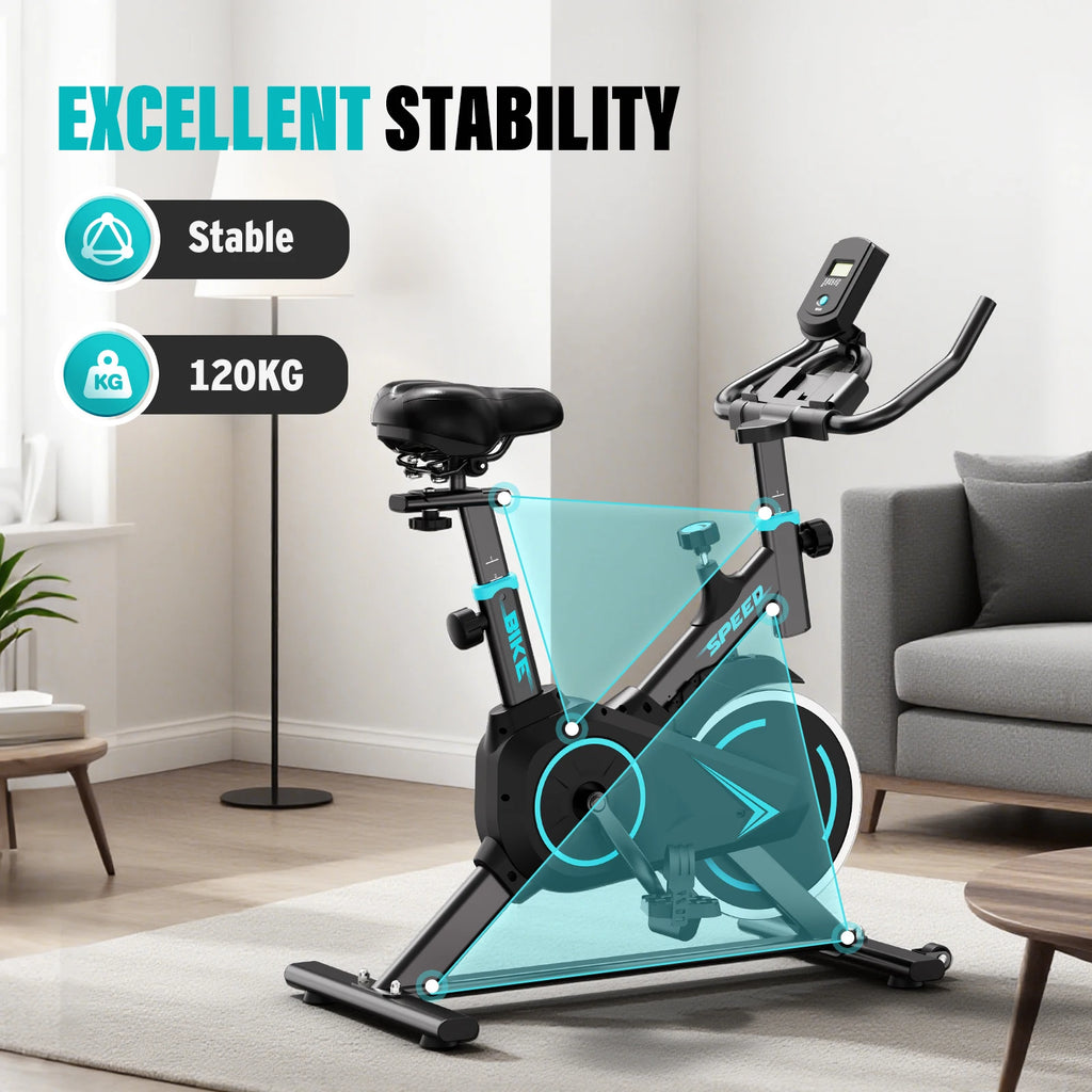 Upright spin exercise bike with LCD display and turquoise frame accents in a living room.