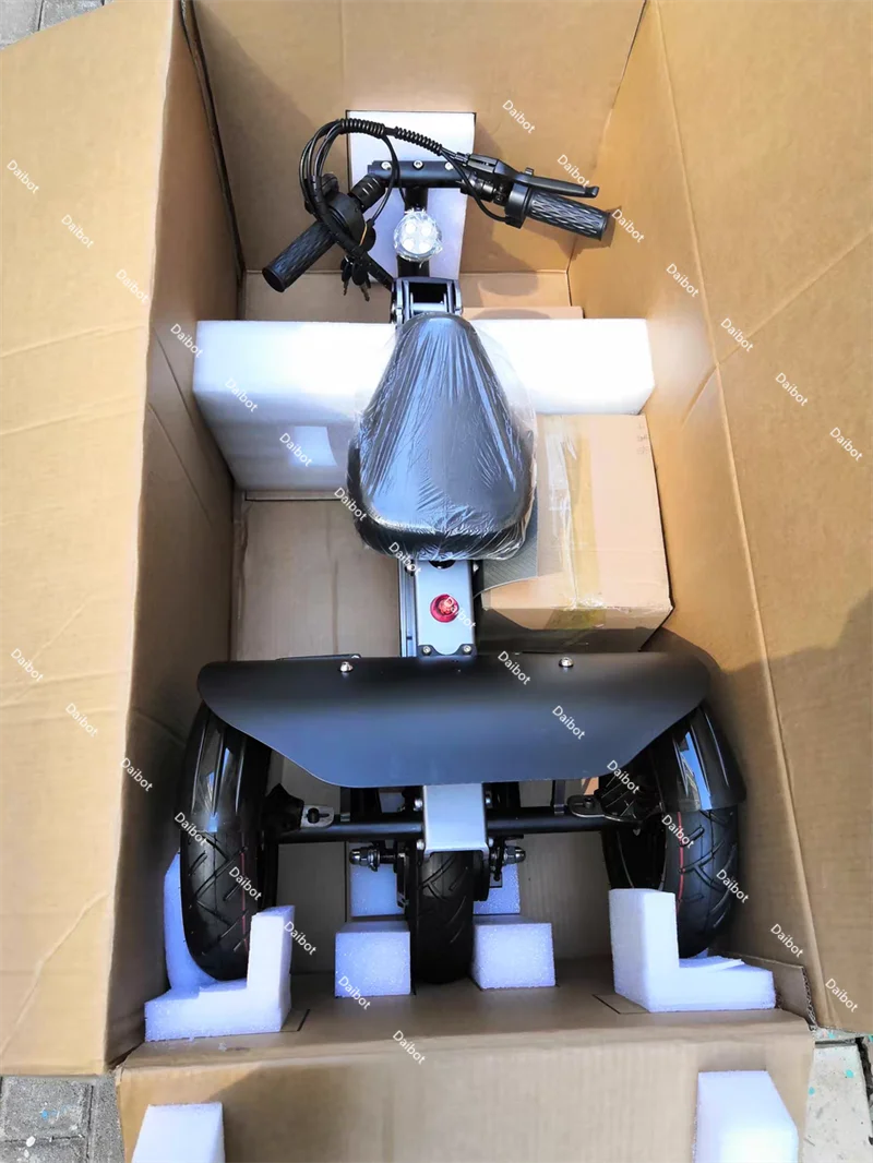 Three-wheel folding electric scooter with seat in black, boxed for shipping