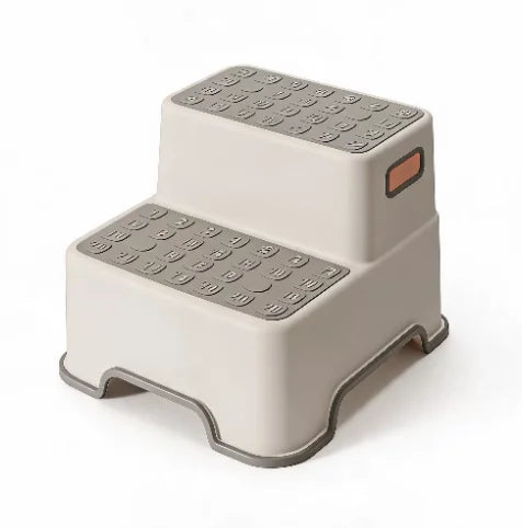 Two-tier beige kids safety step stool with textured gray non-slip metal steps