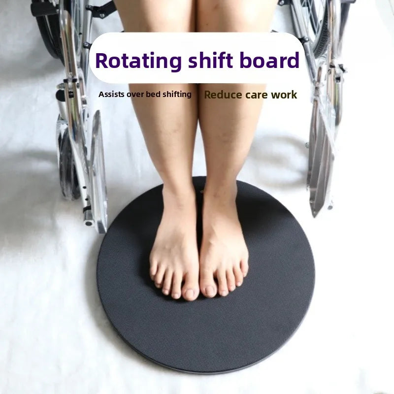 Rotating shift board turntable for over-bed transfers; black round platform beside wheelchairs in home care.