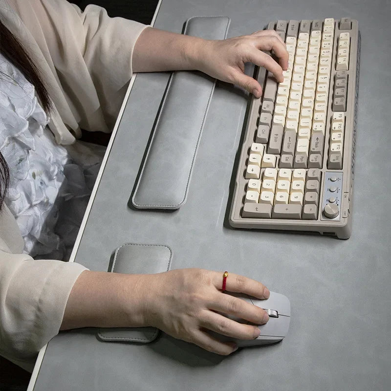 Three-piece PU desk mat set: large waterproof gray mouse pad, long keyboard wrist rest, and palm rest.
