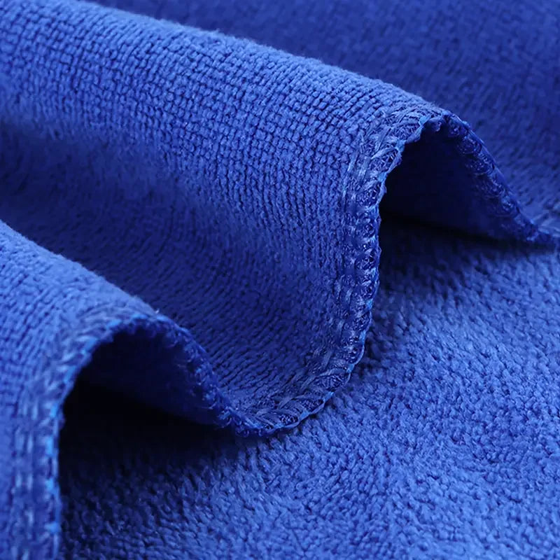 Soft microfiber towels in various colors, ideal for drying and all-purpose use, displayed on a clean surface.