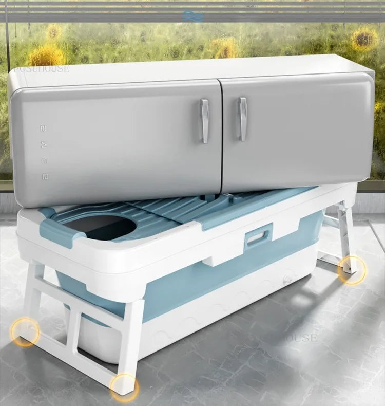 Portable folding bathtub with blue interior on a white stand and lid, MobilityBuy.com