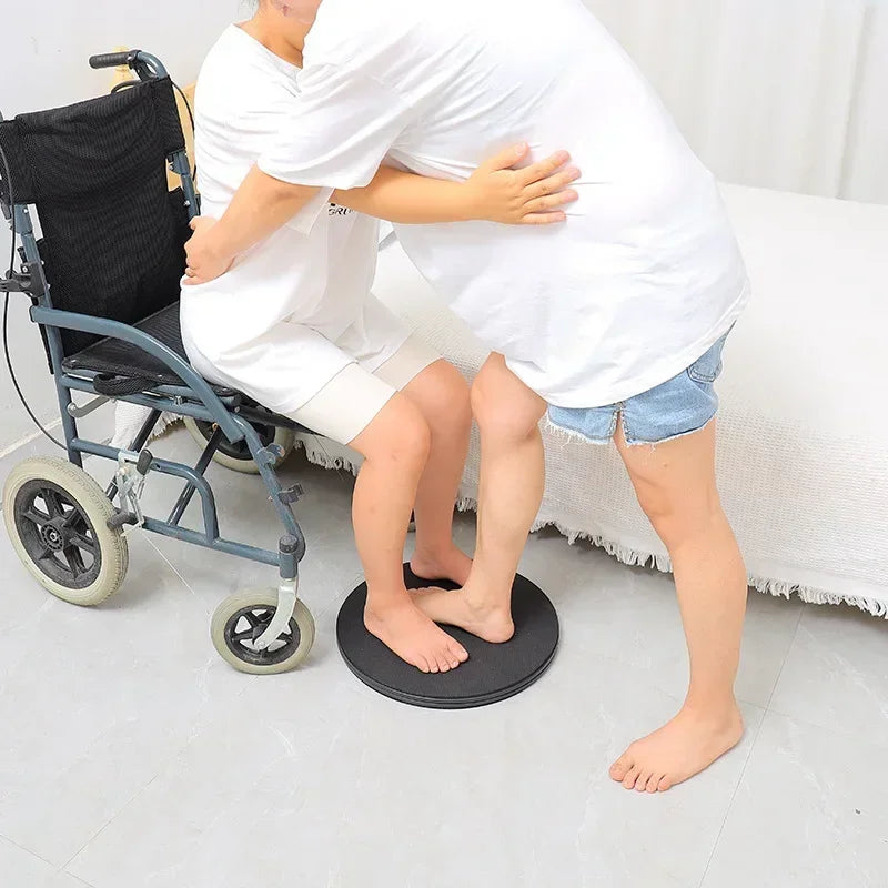 Rotating bed-to-wheelchair transfer turntable in black by MobilityBuy.com for home care.