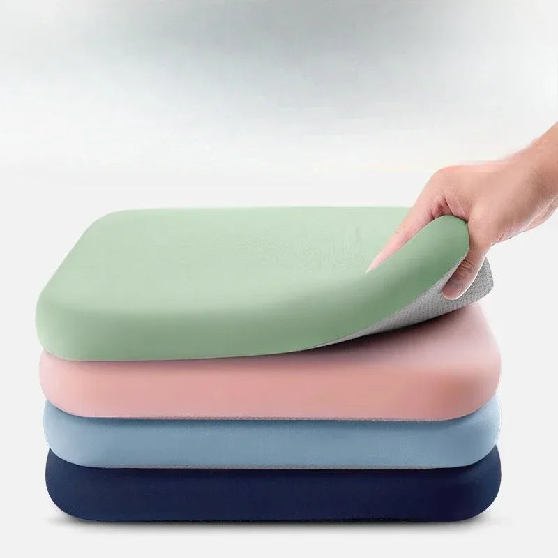 MobilityBuy.com Ultra Thick Soft Foam Seat Cushion four cushions stacked in green pink blue navy with hand lifting top
